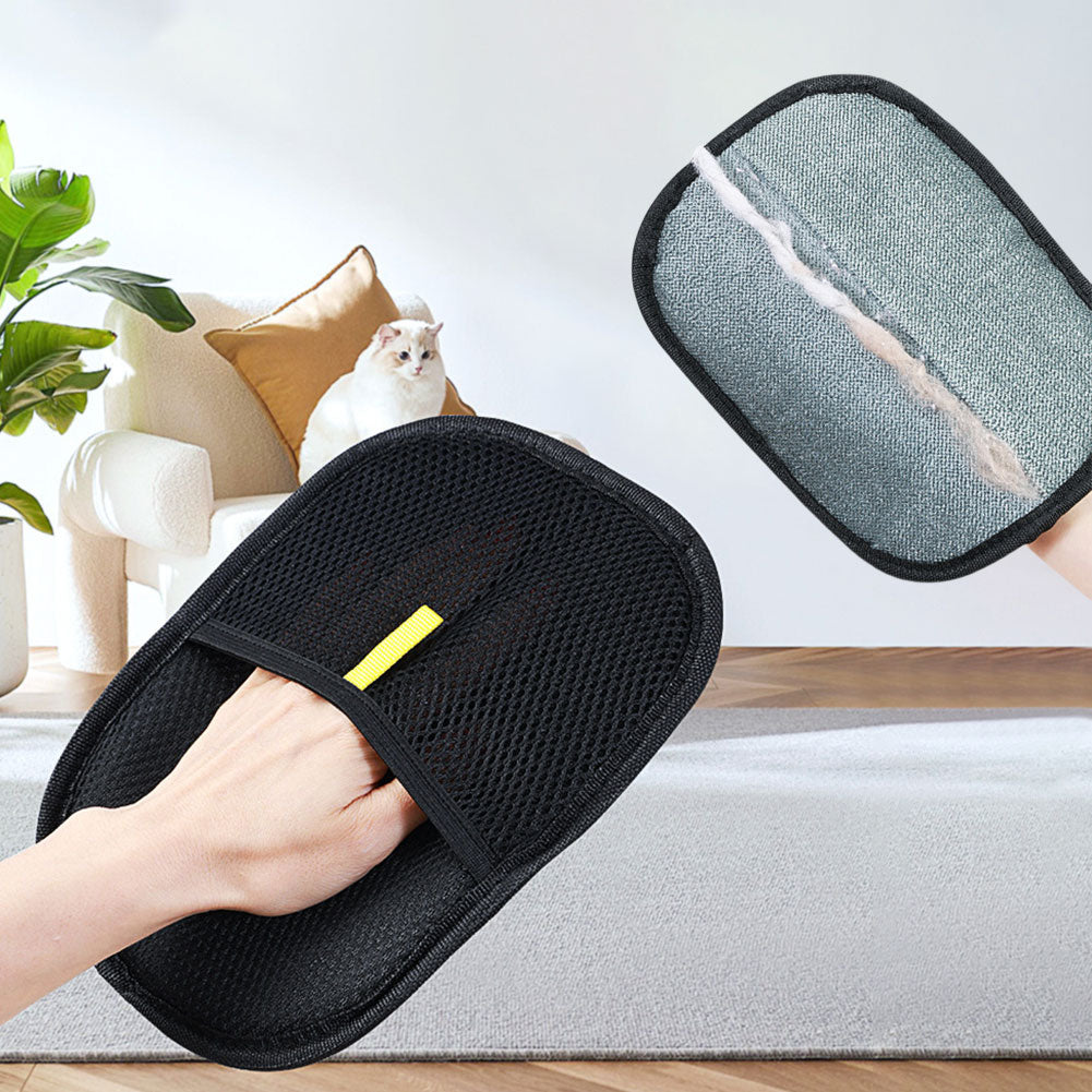 Hand in the mesh mitt in a living room, next to the grey side of a second mitt holding a line of pet hair